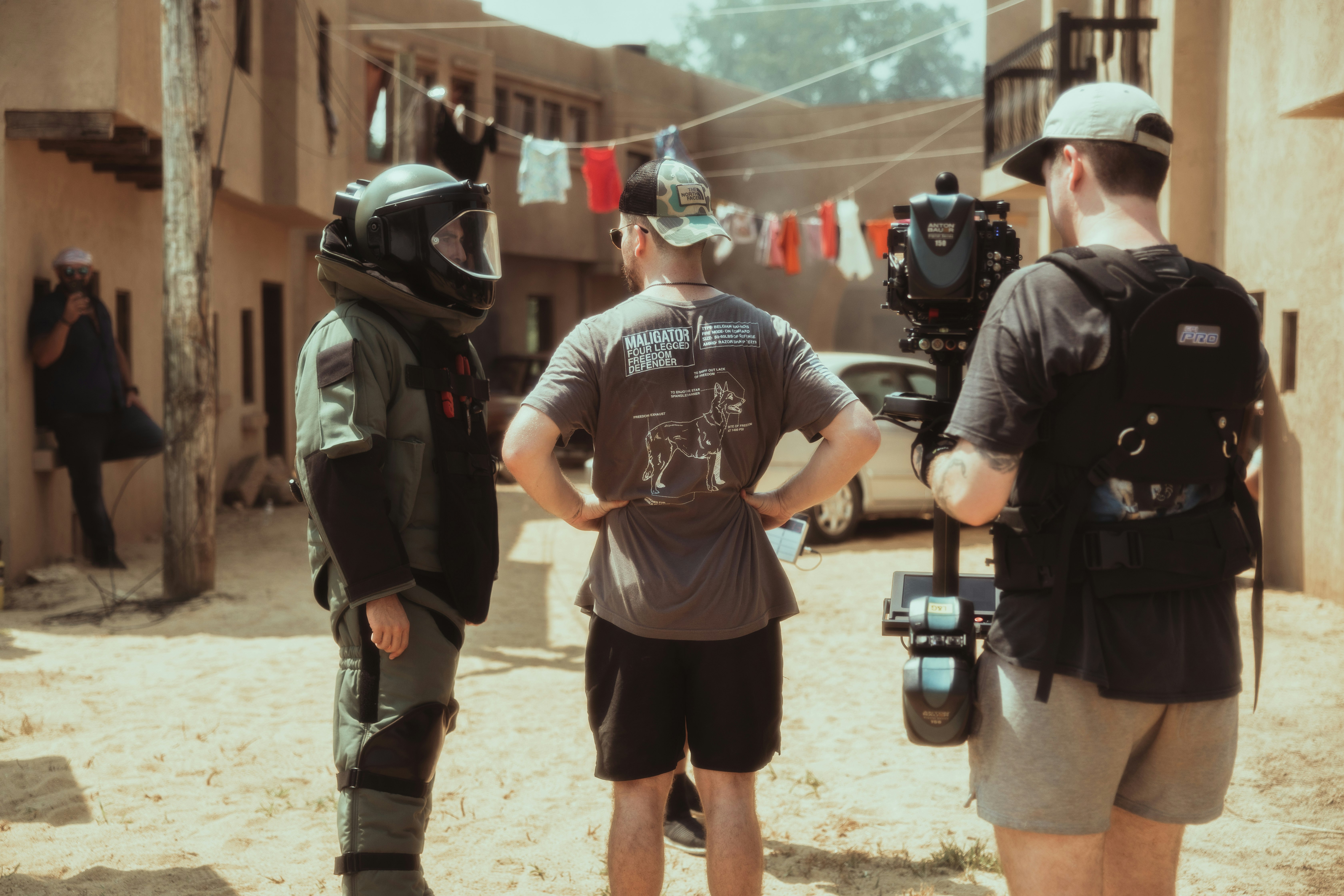 2 men in gray crew neck t-shirt and black shorts holding black and gray dslr